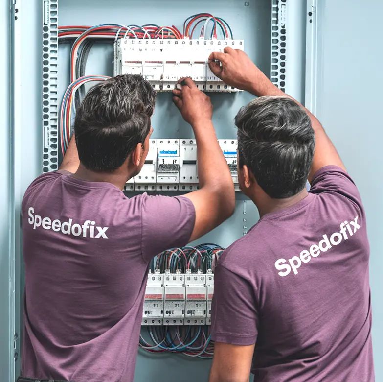 SpeedoFix electricians troubleshooting an electrical distribution board in a warehouse at Al Quoz, Dubai.