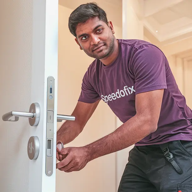Handyman from Speedofix installing a door lock in a villa at Palm Jumeirah, Dubai.