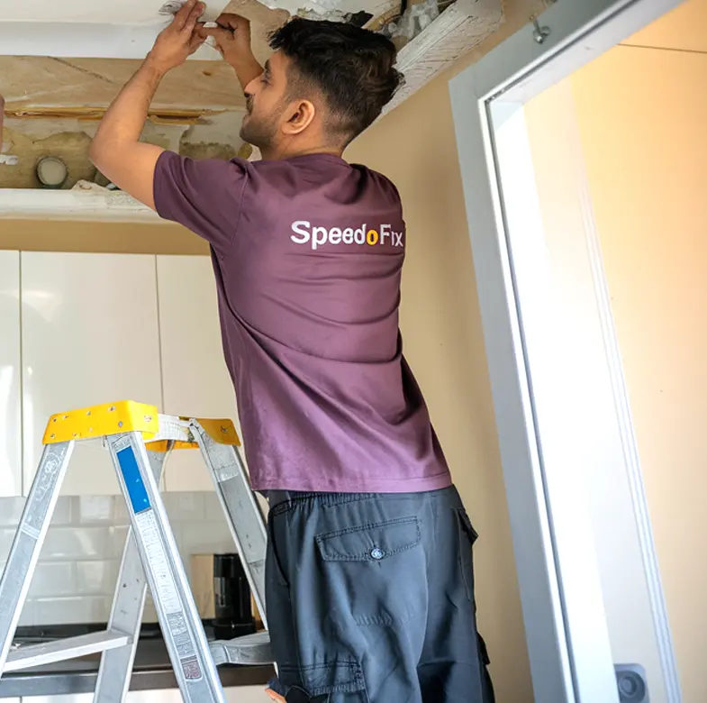 SpeedoFix handyman repairing the ceiling of an apartment at Jumeirah Lake Towers, Dubai.
